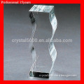 crystal glass trophy in the shape of a wave.